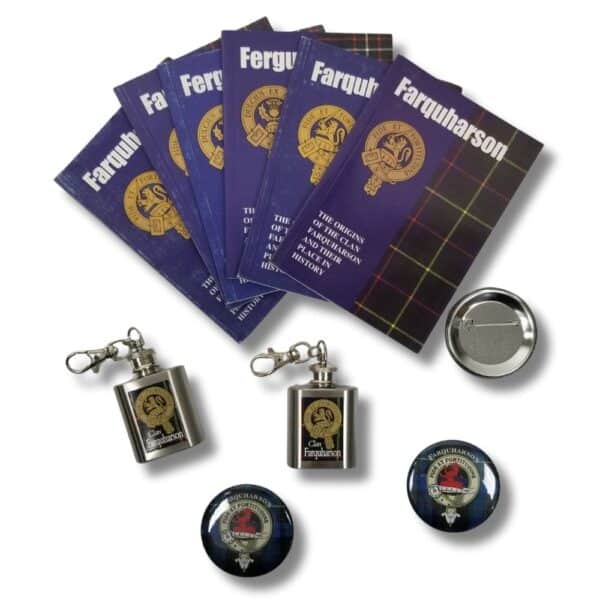 Booklets titled "Armstrong Clan" are accompanied by three small keychain flasks and four round badges displaying various crest designs.