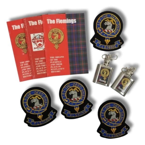 Books titled "The Flemings," along with crest patches and keychain flasks adorned with crest designs, reflect the rich legacy of Scottish heritage celebrated by the Armstrong Clan.