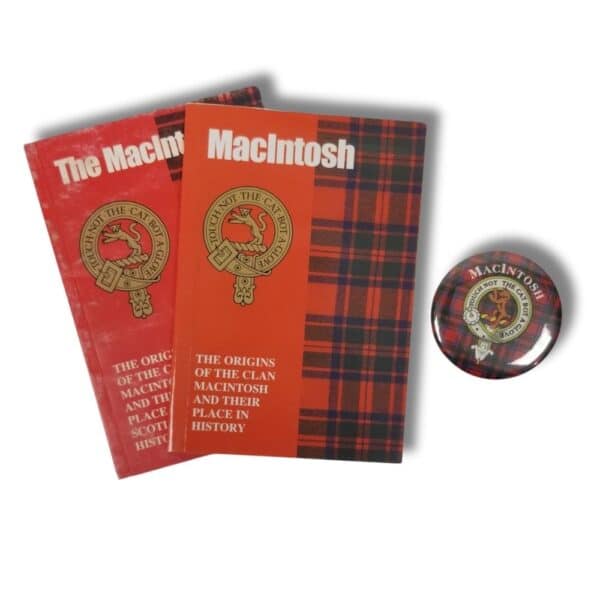 Two red plaid-covered books titled "The Origins of the Clan Macintosh and Their Place in History" sit beside a round button adorned with the same theme and insignia, reflecting a shared heritage similar to that of the Armstrong Clan.