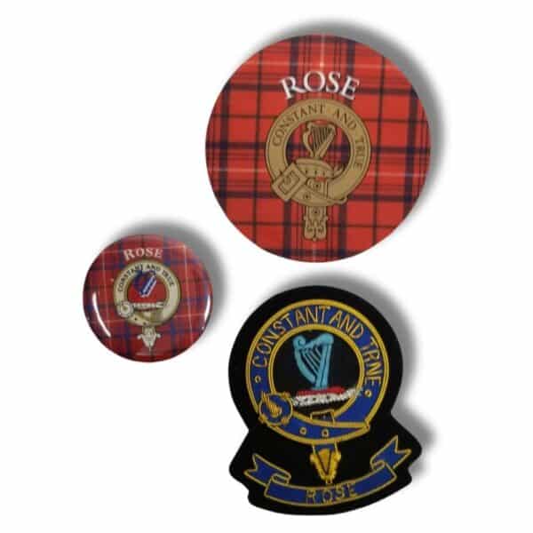 Three Armstrong Clan emblems on a red tartan background: a large button, a small button, and a patch, all featuring the motto "Constant and True" with a harp emblem—a tribute to the rich heritage of Scottish clans.