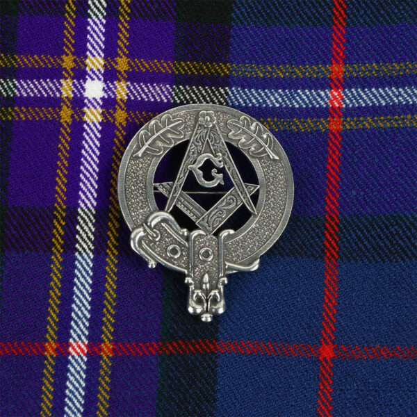 A Masonic Pewter Kilt Belt Buckle on a plaid with a Masonic Crest.