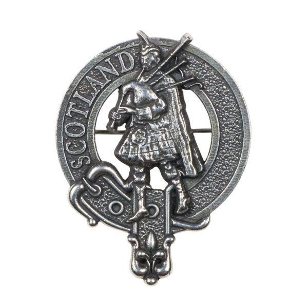 A Scottish Piper Cap Badge/Brooch featuring a claddagh design on a white background.