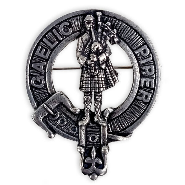 A Scottish Piper Cap Badge/Brooch with a metal piper on it.