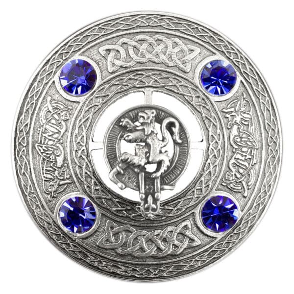 A celtic stag with blue sapphires on a silver plate, adorned with a Rampant Lion Plaid Brooch.