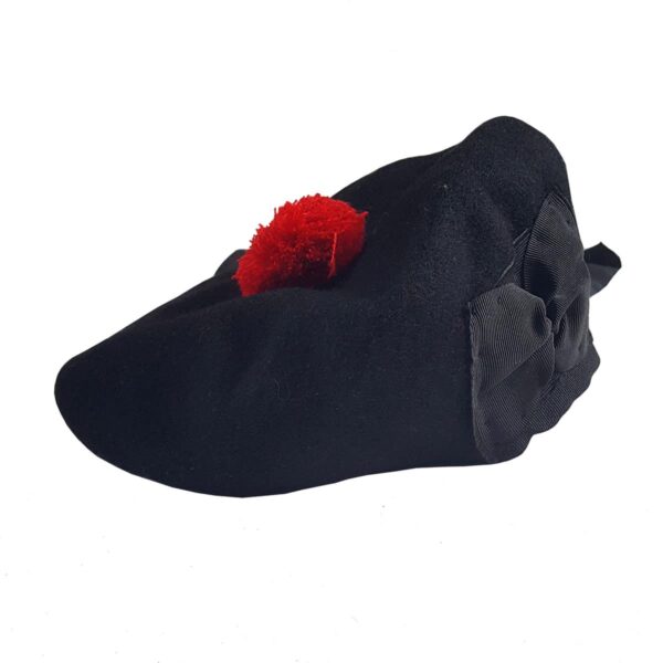 A black beret with a red pom pom and a Felted Wool Balmoral.