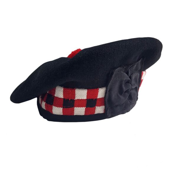 A black and red Felted Wool Balmoral beret with a bow on it.