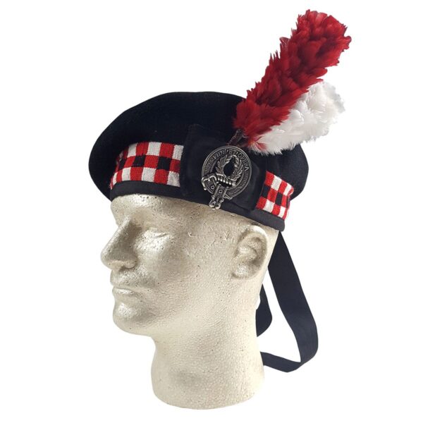 A mannequin head with a Felted Wool Balmoral hat and a kilt wrapped around it, adorned with a feather.
