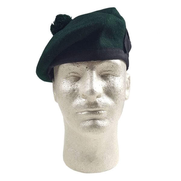 A mannequin wearing a green beret and Felted Wool Balmoral.