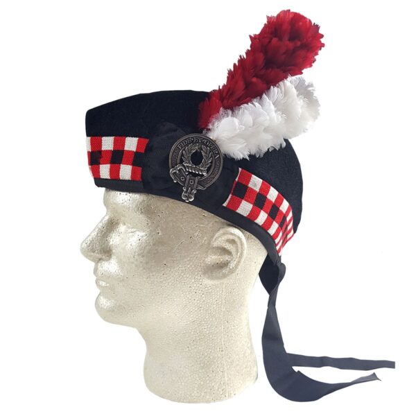 A mannequin wearing a kilt with a red and white feather and a Felted Wool Glengarry hat.