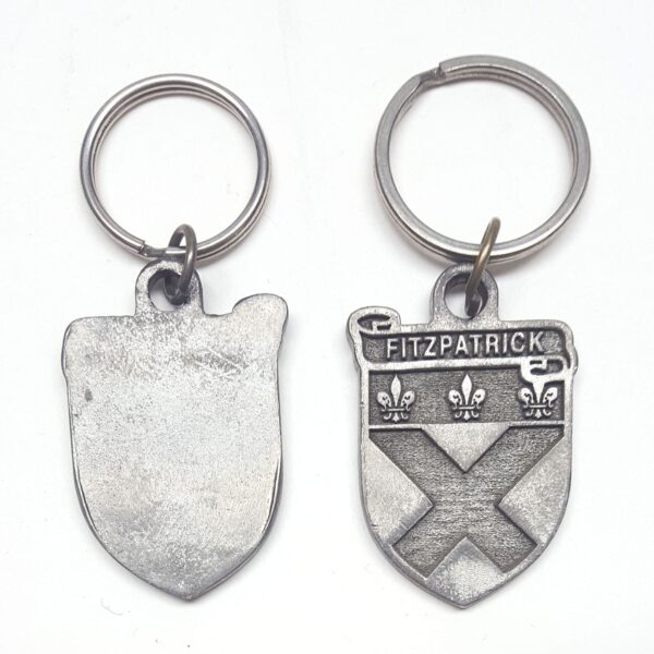 Two Irish Coat of Arms keychains featuring a shield and a cross. - Irish Coat of Arms Key Chain - Clearance - Weathered