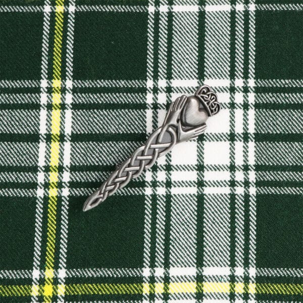 An Irish Irish Claddagh Kilt Pin on a green and yellow plaid.