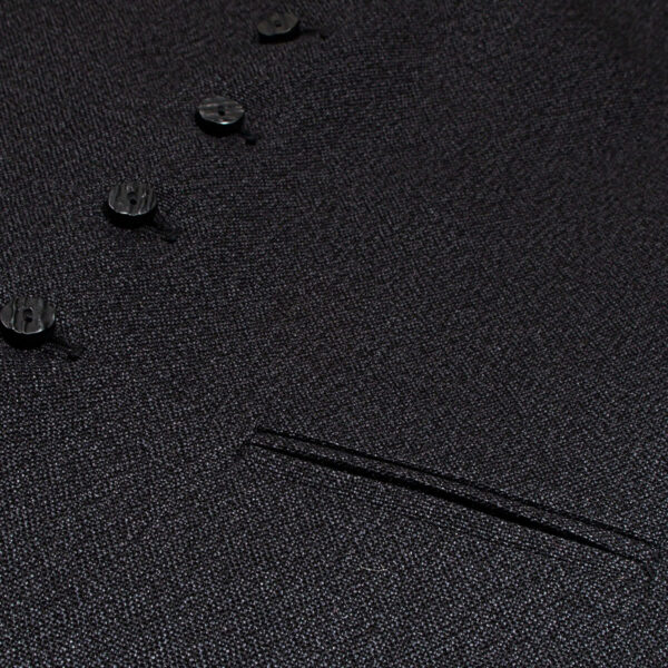 A close up of a black suit with buttons and a Tweed 5 Button Vest.