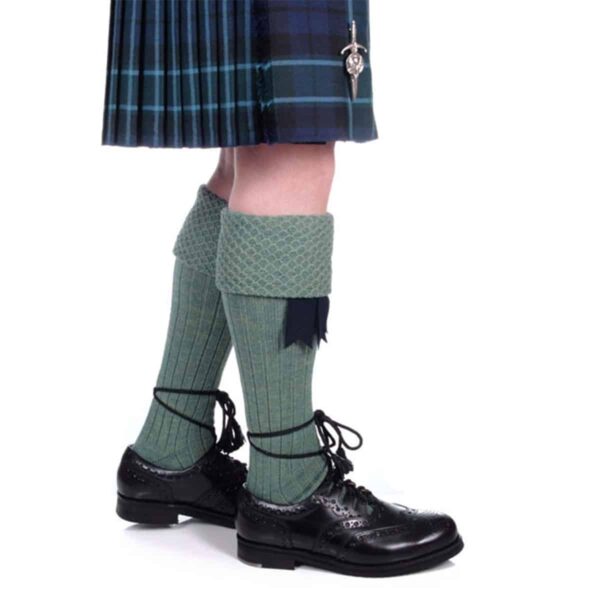 A Piper wearing a kilt and Piper Kilt Hose (Special Order).