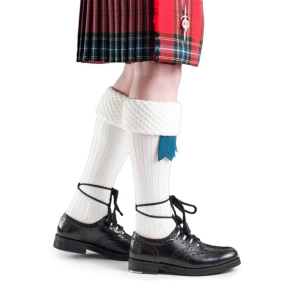 A Piper Kilt Hose (Special Order) wearing a kilt and kilt hose.