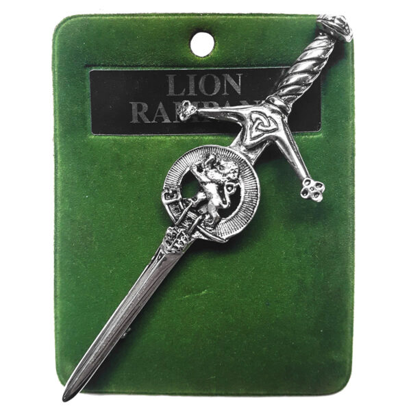 An Art Pewter Rampant Lion Kilt Pin on a green background.