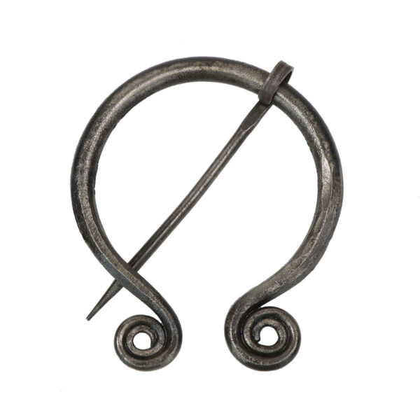 A black wrought iron penannular brooch with a spiral design.