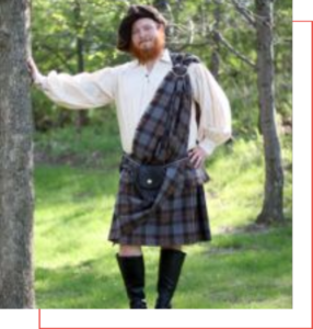 A man in a kilt leaning against a tree, showcasing the traditional attire mentioned in the kilt buyer guide.