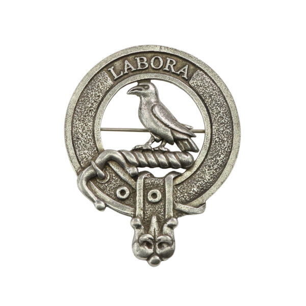 A MacKie Pewter Clan Crest Cap Badge/Brooch featuring a silver claddagh with a crow on it is called the MacKie Pewter Clan Crest Cap Badge/Brooch.