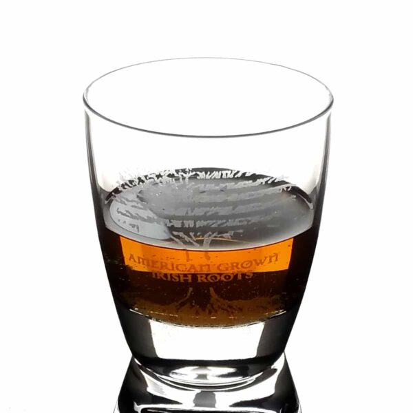 An image of an American Grown with Irish Roots Whisky Glass with a label on it.