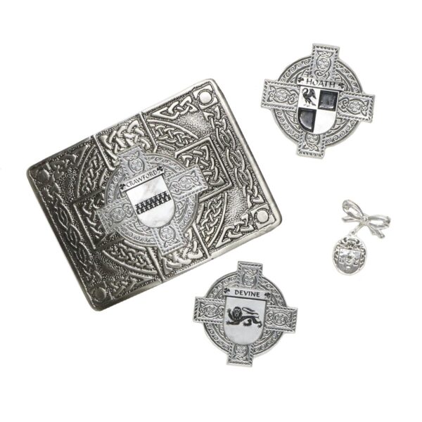A set of celtic brooches and pins on a silver plate.