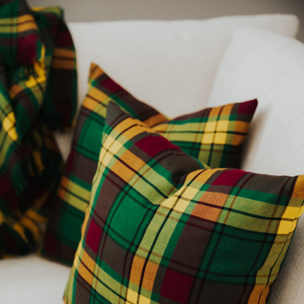 Two Homespun Tartan Blanket/Throws on a couch.