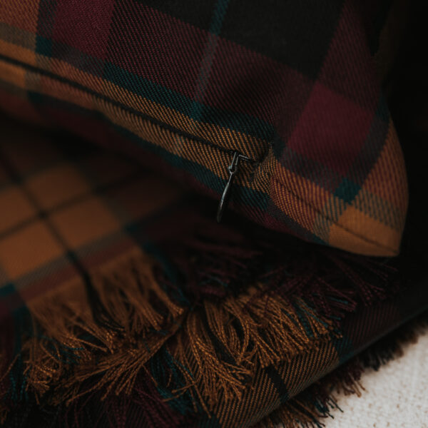 A close up of a Homespun Tartan Blanket/Throw with tassels.