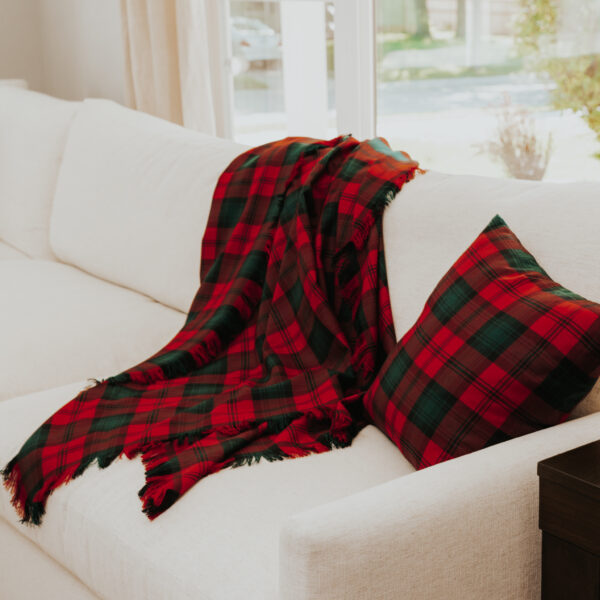 A Homespun Tartan Blanket/Throw on a couch in a living room.