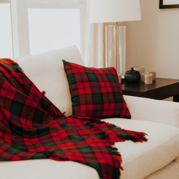 A Homespun Tartan Blanket/Throw on a white couch.