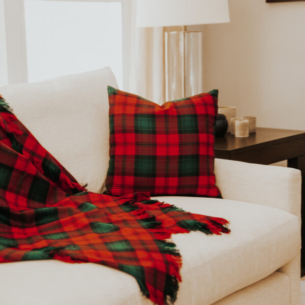 A Homespun Tartan Blanket/Throw thrown on a couch in a living room.