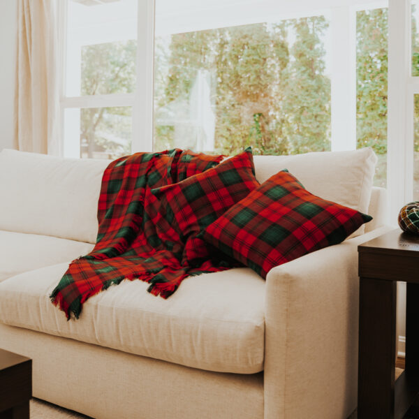 A Homespun Tartan Blanket/Throw on a couch.