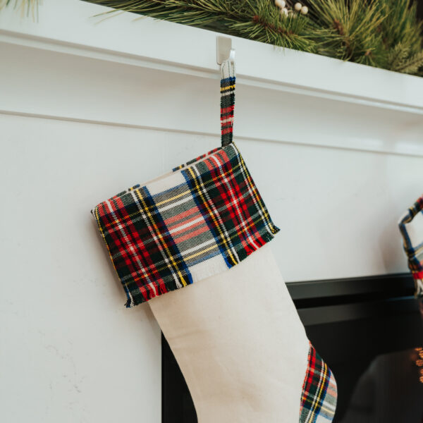 Two Tartan Stockings with Toes - Homespun Wool Blend hanging on a mantle.