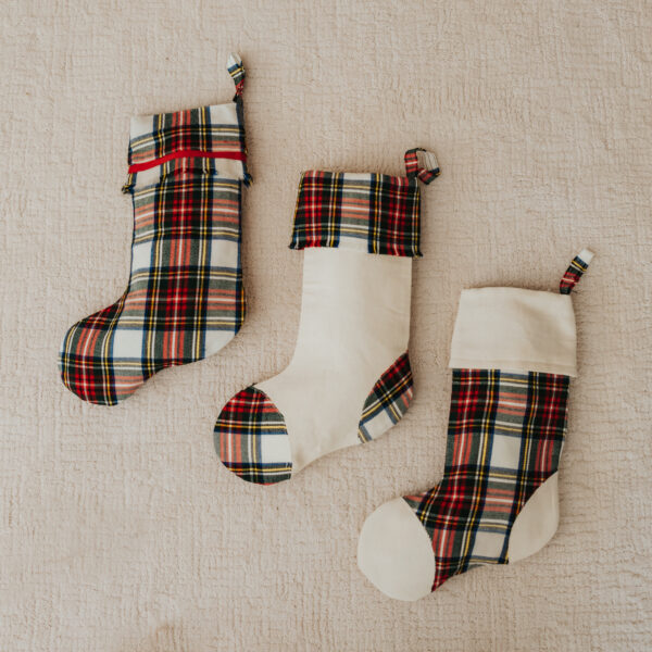Three Tartan Stocking with Toes - Homespun Wool Blend on a bed.