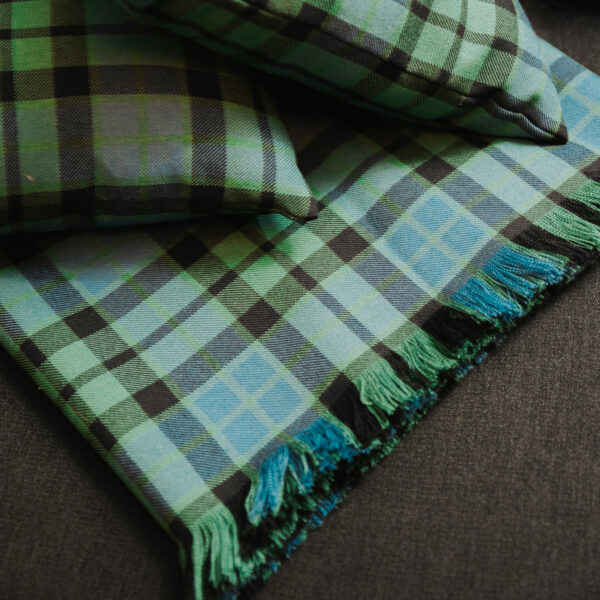 A Homespun Tartan Blanket/Throw with fringes.