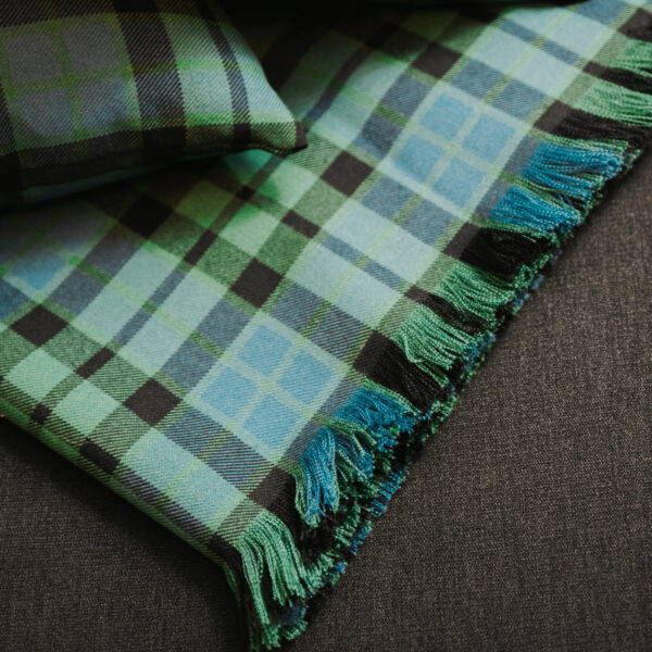 A green and blue Homespun Tartan blanket/throw with fringes.