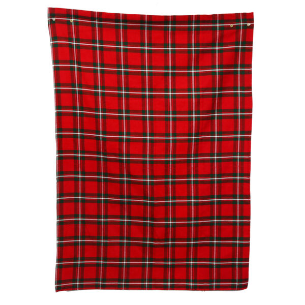 A red and black plaid blanket hanging on a white wall.