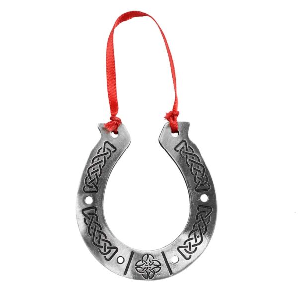 A silver Lucky Horseshoe ornament with a red ribbon, featuring a Scottie Dog.
