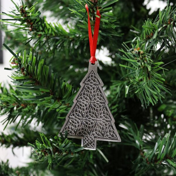 A silver Trinity Knot Tree Ornament hanging on a tree.