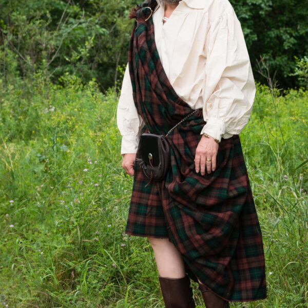 A man in a Great Kilt - Poly/Viscose Wool-Free standing in a field.