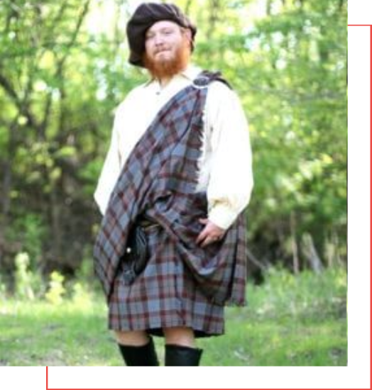 A man in a kilt standing in the woods, showcasing the traditional charm and versatility of this timeless garment.