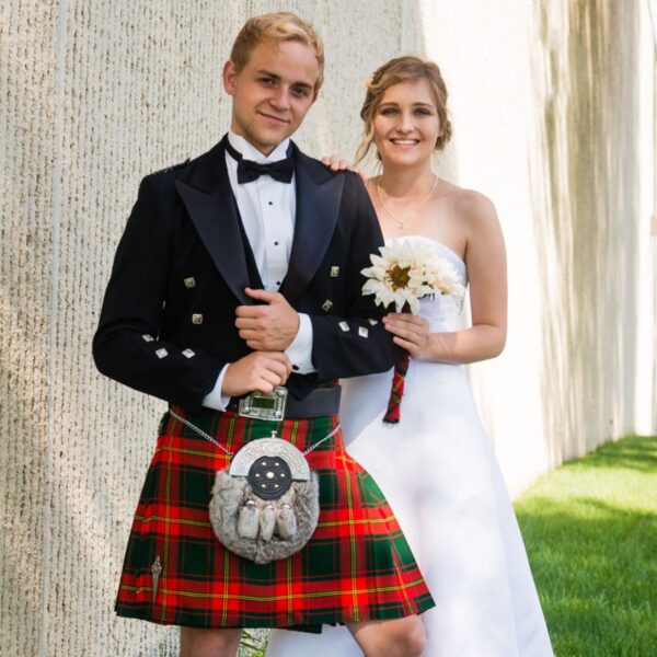 A bride and groom in a kilt.