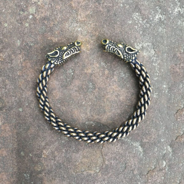 Description: A black and gold Celtic Dragon Torc Bracelet, perfect for those who embrace their inner wild spirit.
