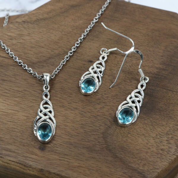 A Triquetra sterling silver necklace and Triquetra sterling silver earrings set with blue topaz.
