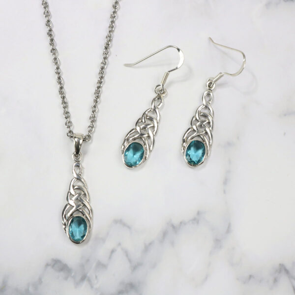 A necklace and earrings set with blue crystals and the Triquetra Sterling Silver Earrings.