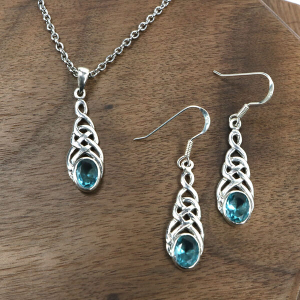A sterling silver necklace and Triquetra Sterling Silver Earrings set with blue crystals.