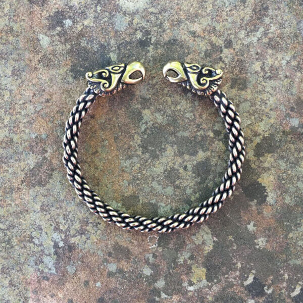 A Celtic Griffin Torc Bracelet - Light Braid featuring two griffin heads.