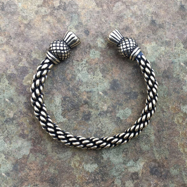 A Celtic Thistle Torc Bracelet with a braided pattern.
