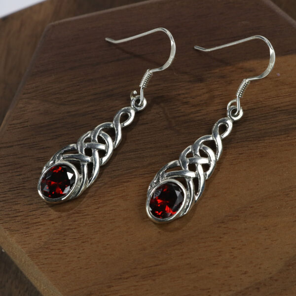 These Celtic Knot Garnet Earrings are made of sterling silver.