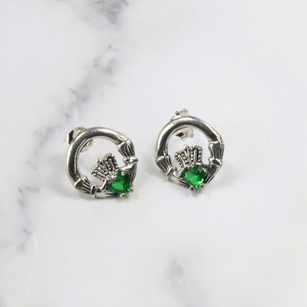 A pair of emerald-claddagh stud earrings with Triquetra sterling silver accents can be replaced with: A pair of Triquetra sterling silver earrings.