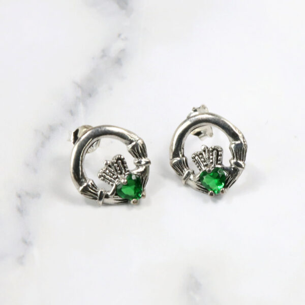 Beautiful Claddagh earrings featuring elegant emerald stones. 

Claddagh Earrings with Green Stone.