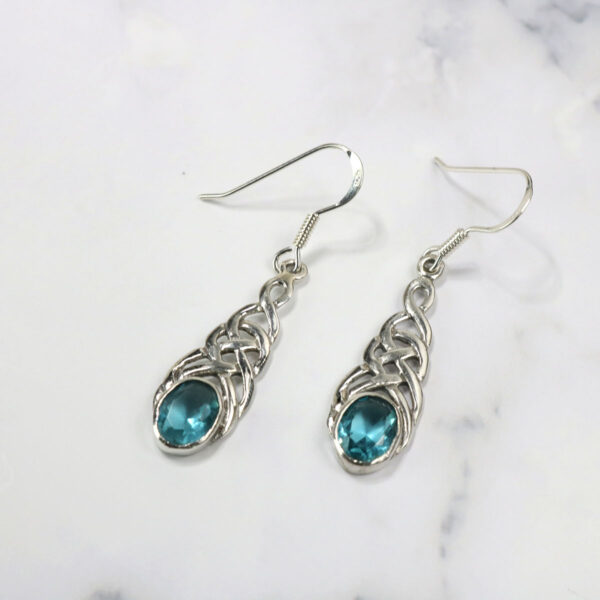 A pair of Triquetra Sterling Silver Earrings with blue crystals.